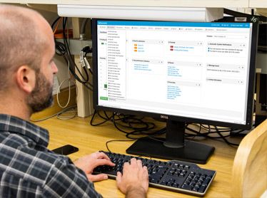 Man looking at a monitor with iDocuments Purchase to Pay on the screen