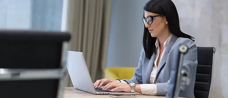 Business person on laptop testing Shopify Integration for Sage Intacct