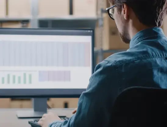 Businessman wearing glasses analyzes spreadsheet data
