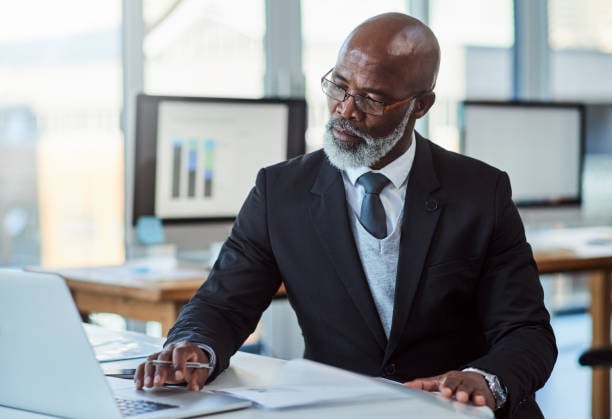 Older business man on Laptop using SAP Business One