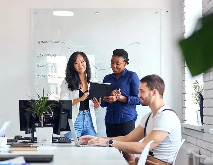 Co-workers review SAP Business Technology Platform (BTP) in the office, learning how to connect end-to-end processes