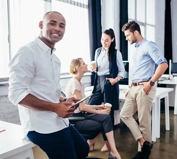 Workers in an office setting discussing SAP Business Technology Platform (BTP) over coffee