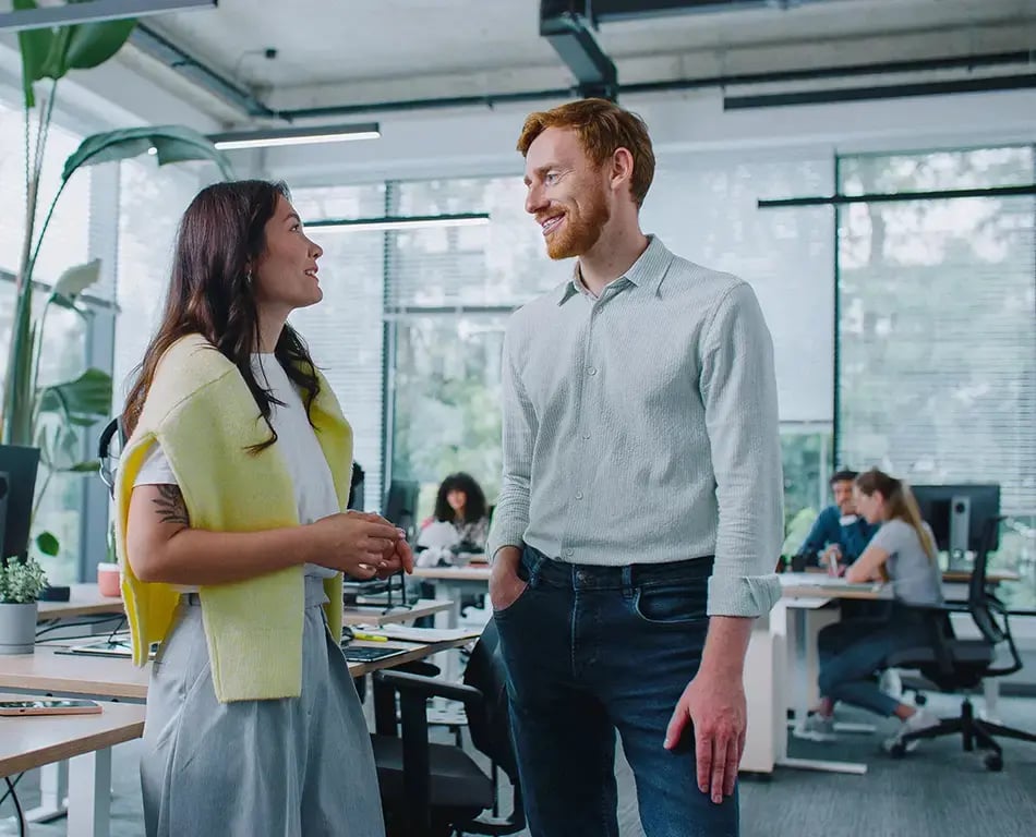 Co-workers discuss Sage Intacct Success Assurance in the office
