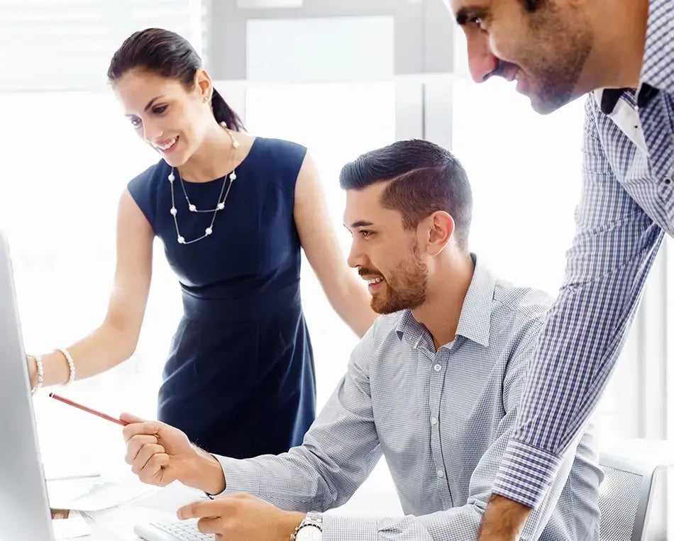 Business co-workers look at a screen showing their Hubspot integration