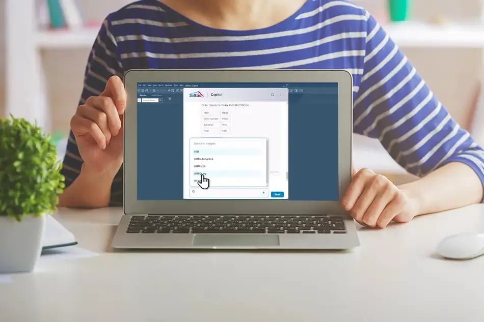 Woman on laptop showing a screenshot of the SAP Business One-Copilot integration